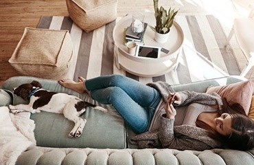 Dog and owner lying on a sofa in a living room