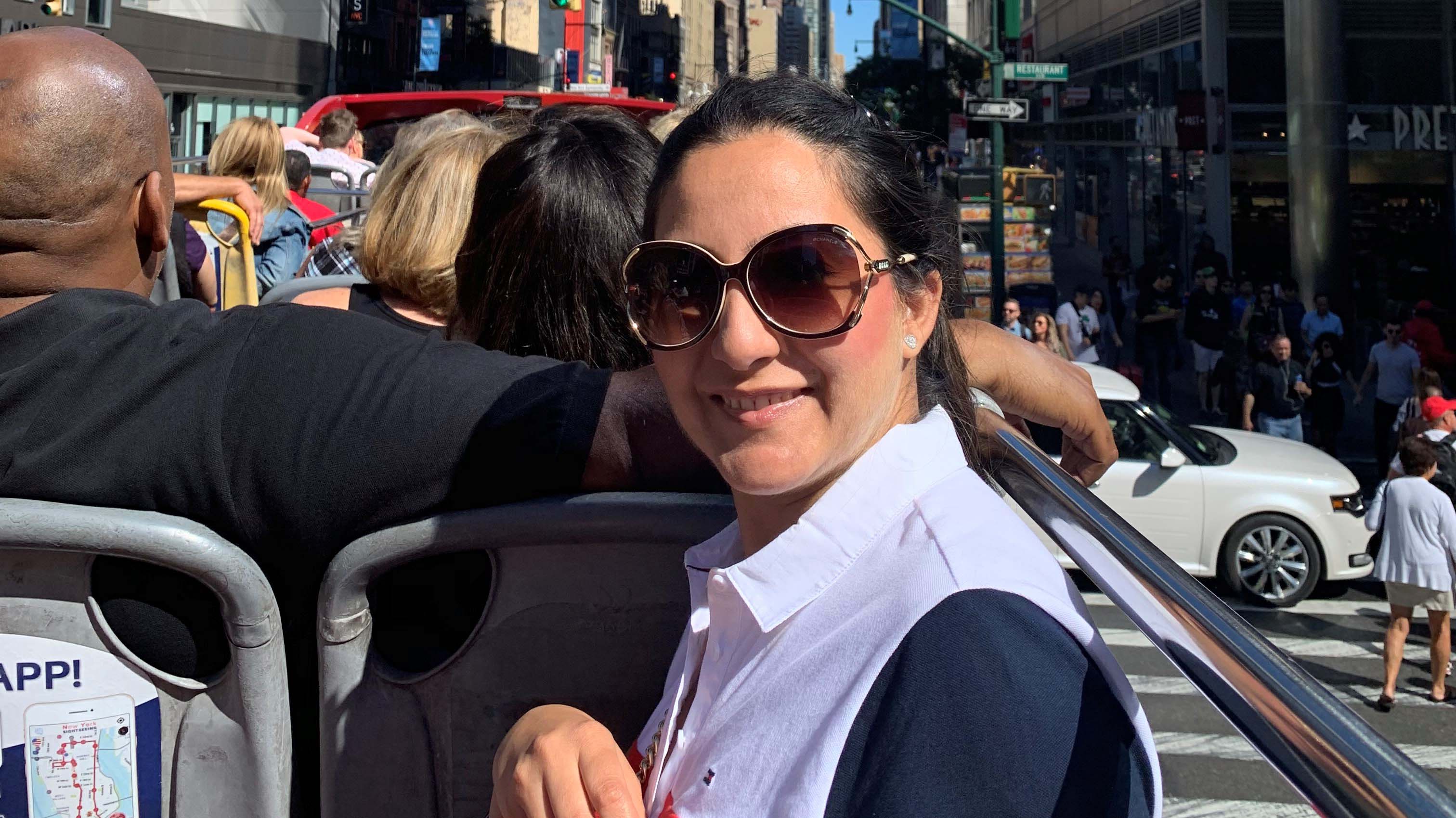 Amandeep wearing sunglasses on open top bus