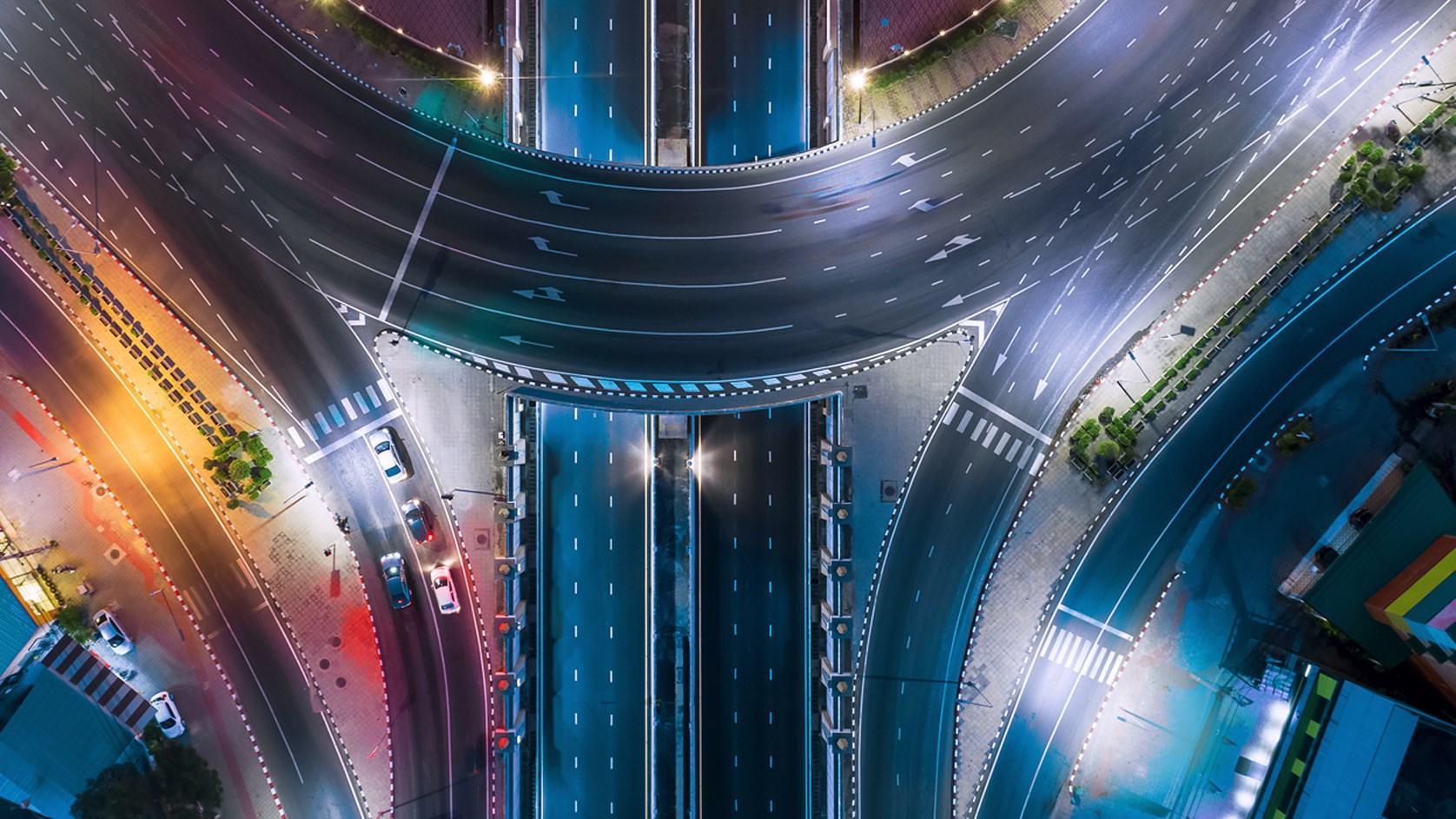 An aerial top view of a Bangkok roundabout road at night - Thailand.