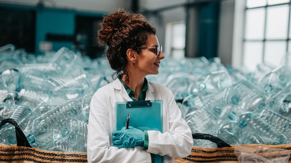 Female stood in a bottling plant.