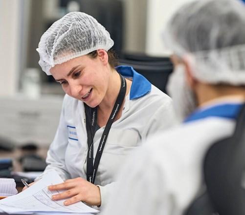 Reckitt lab employees examine paperwork