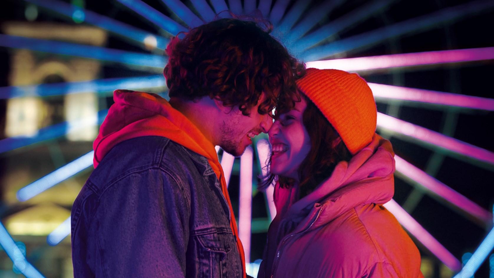 Young happy couple at a fairground