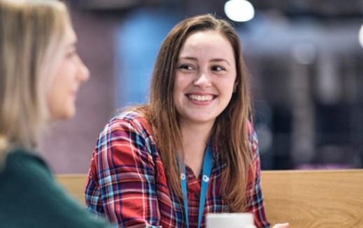 Young woman smiling at her colleague