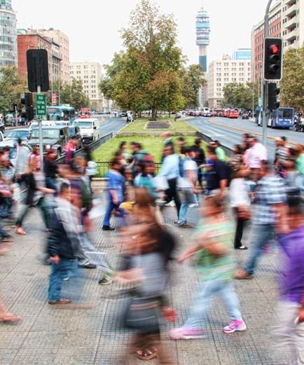 People walking across a busy city street