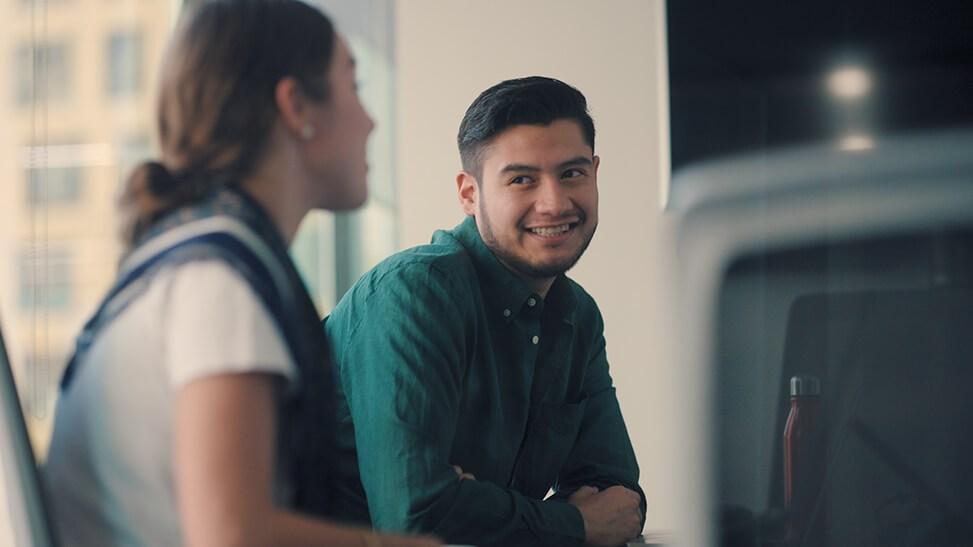 Young man smiling at his colleague