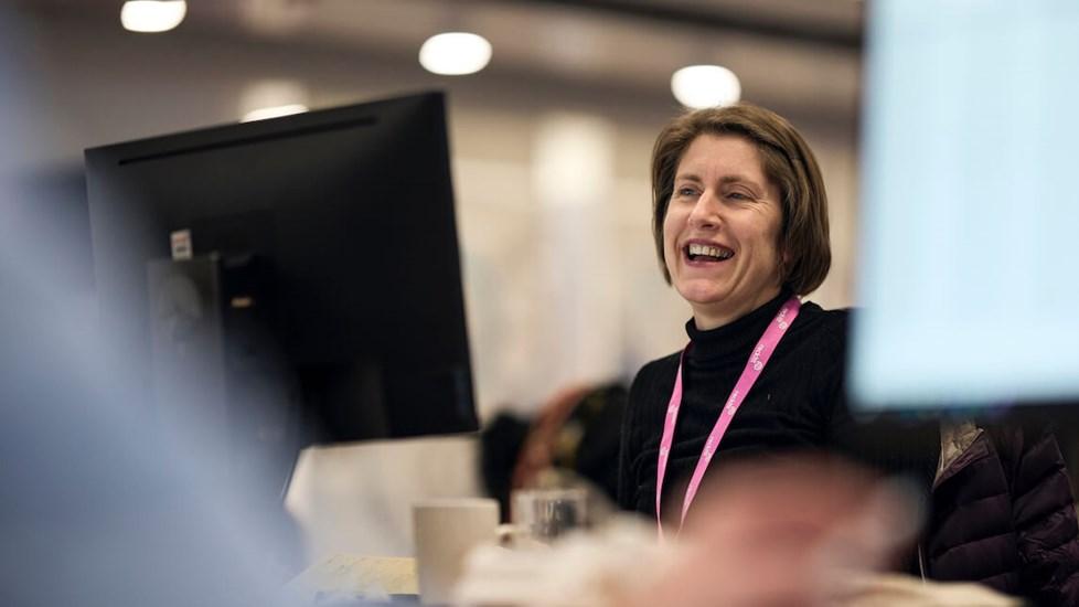 A Reckitt employee working on a computer